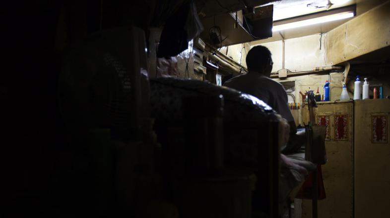 razno 07.02.13. revscina, Peng, a 61-year-old man, reads newspapers on a bed he 
