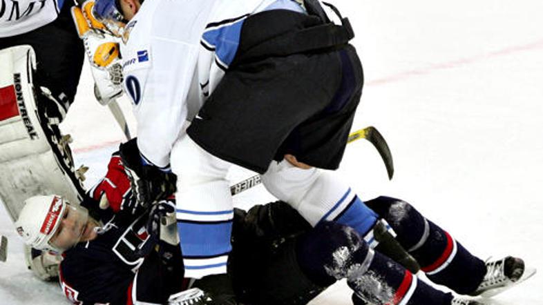 Jere Karalahti (beli dres) med pretepanjem na ledeni ploskvi