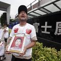 Obupani starši umrlega Maa Xiangqiana. (Foto: Reuters)