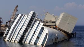 razno 12.09.13. The capsized cruise liner Costa Concordia lies surrounded by cra