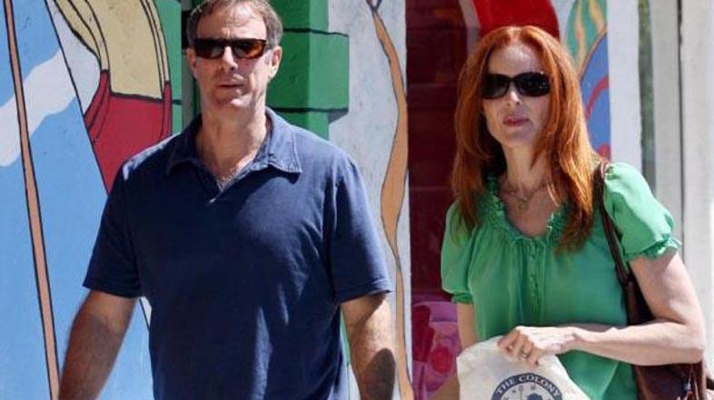 Igralka možu ves čas stoji ob strani.