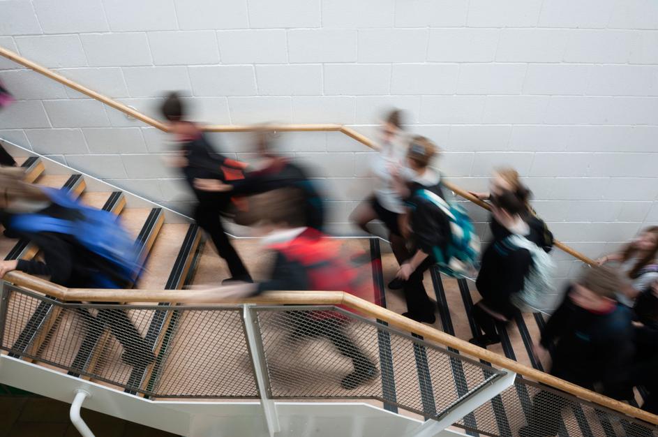 učenci hodijo po stopnišču v šoli