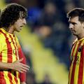 Carles Puyol in Lionel Messi 