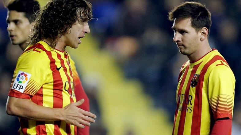 Carles Puyol in Lionel Messi 