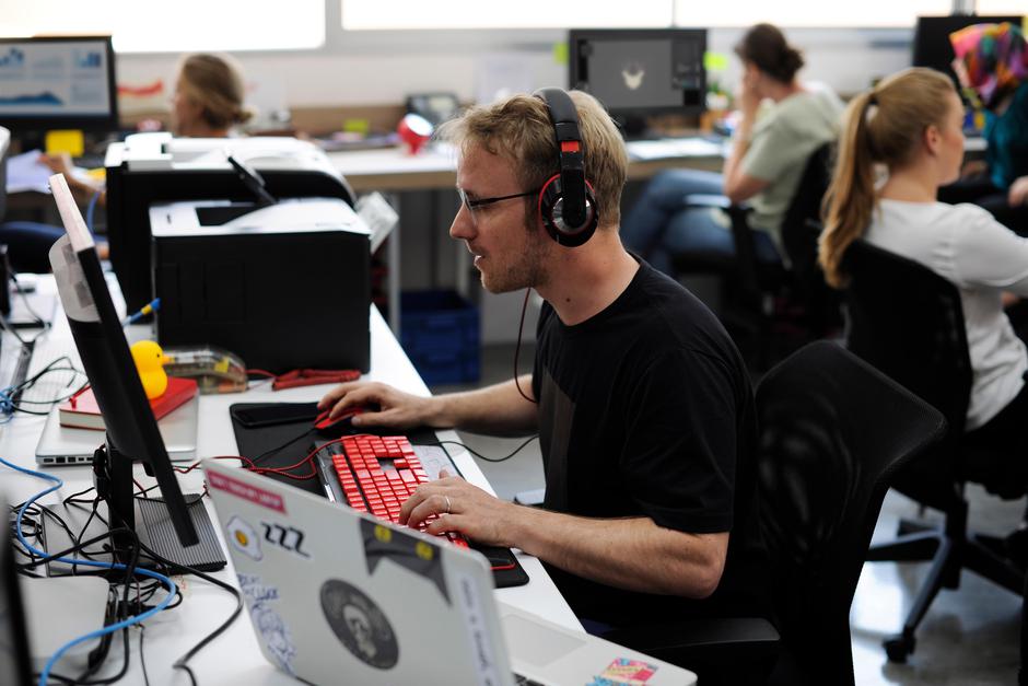 Delavci v pisarni, moški s slušalkami | Avtor: Profimedia