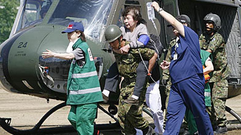 Japonski reševalci se trudijo, da bi na varno prepeljali čim več ljudi z ogrožen