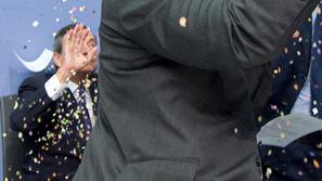 Ženska protestira na tiskovni konferenci ECB.